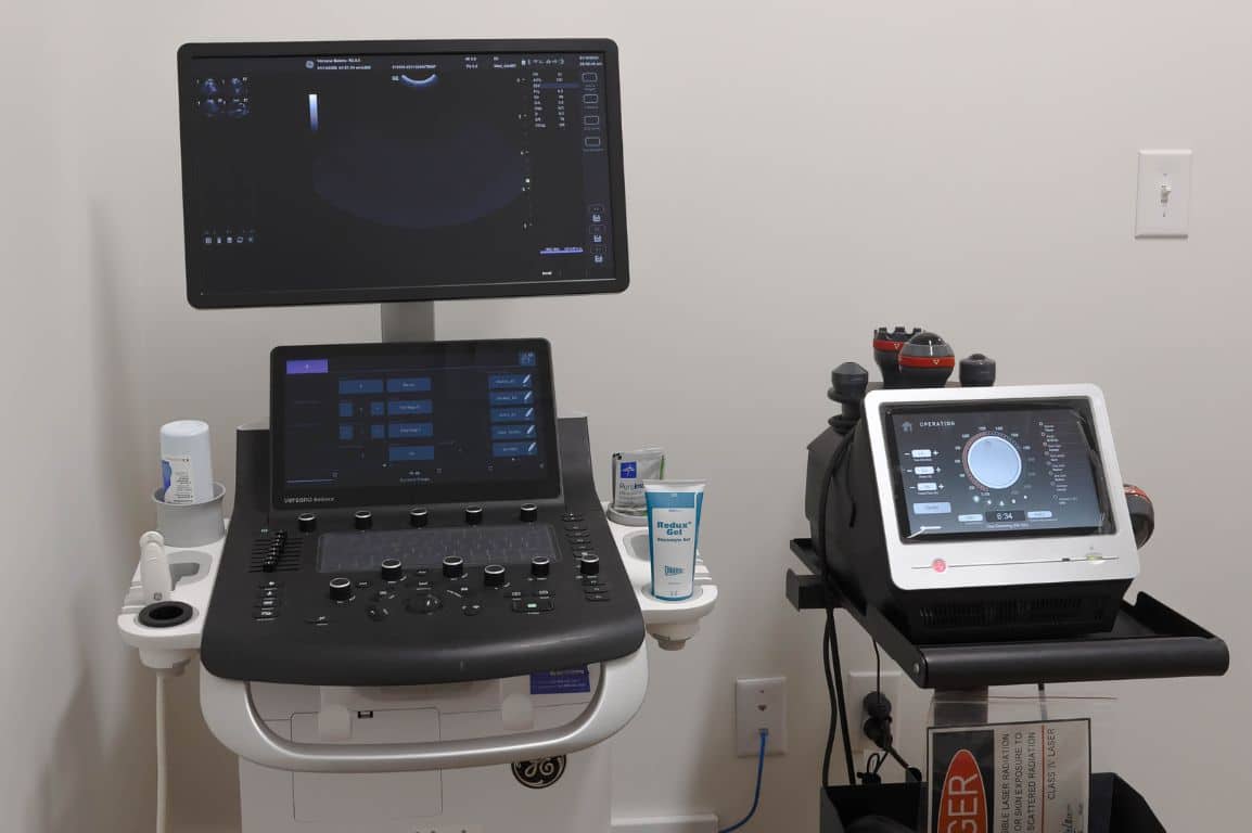 A computer monitor and a second monitor are placed on a desk